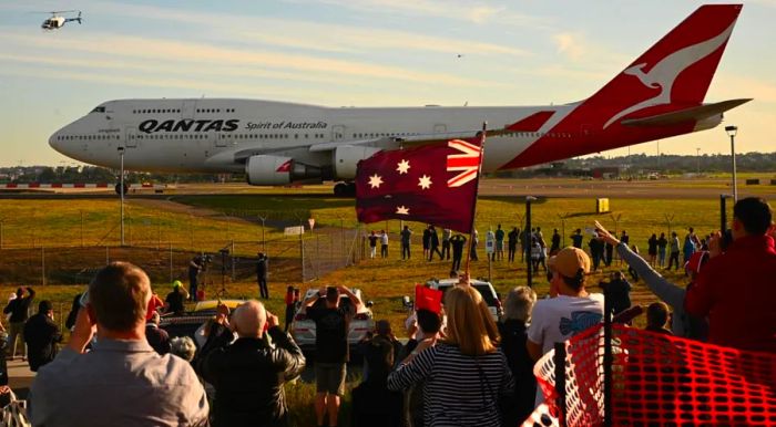 Onlookers gathered as the final Qantas Boeing 747 prepares for its departure from Sydney Airport.