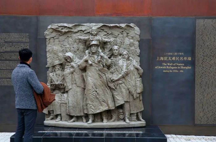 A visitor observes the memorial wall listing the names of Jewish refugees at the Shanghai Jewish Refugees Museum on December 8, 2020.