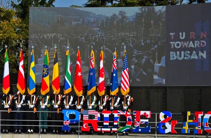 South Korean honor guards proudly carry the flags of UN allied nations during a memorial ceremony for UN veterans of the Korean War, held at the UN Memorial Cemetery in Busan on November 11, 2020.