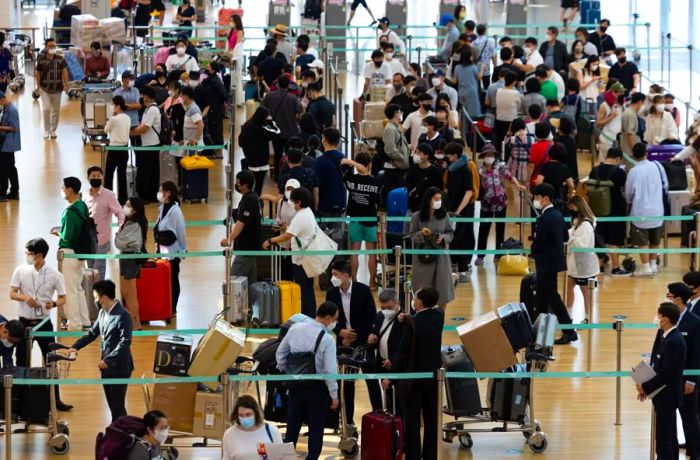 Travelers line up at the Vietnam Airlines counter at South Korea's Incheon International Airport on September 8, 2022.