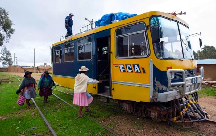 Women boarding a Ferrobus along the Potosi-Sucre route in Bolivia.