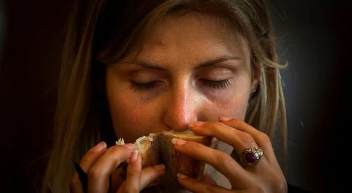 A judge inspects a baguette by smelling it during the 2017 Paris Grand Prix de la Baguette.