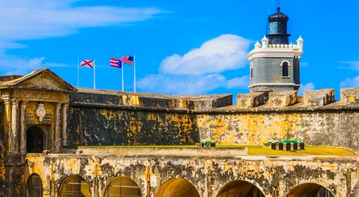 El Morro is safeguarded by a deep moat, sturdy stone battlements, and dramatic sea cliffs that enhance its strategic defense.