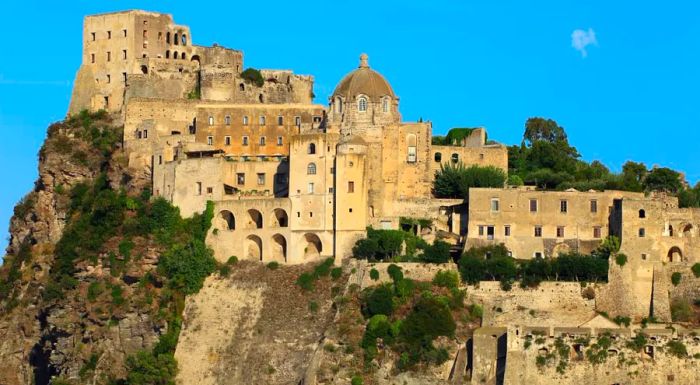 Aragonese Castle offers stunning views across the bay toward Mount Vesuvius.