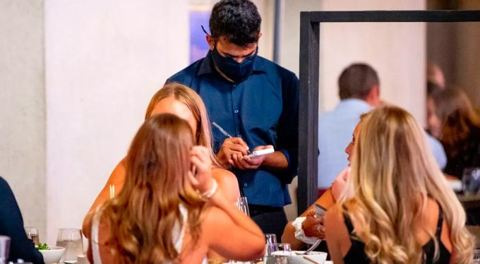 A Nobu server wears a mask during New York's fourth phase of reopening on September 11.