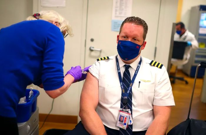 United Airlines pilot Steve Lindland receives a Covid-19 vaccine at O'Hare International Airport in March 2021.