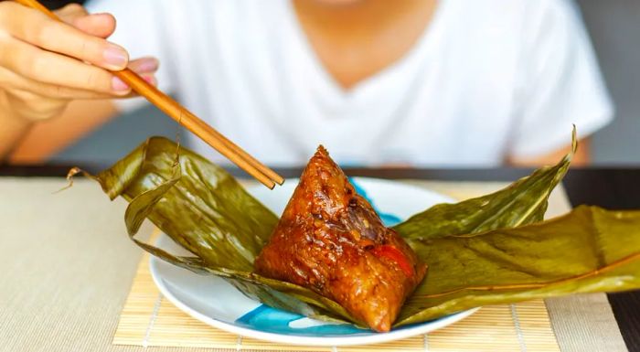 Zongzi are delicious rice dumplings wrapped in bamboo leaves.