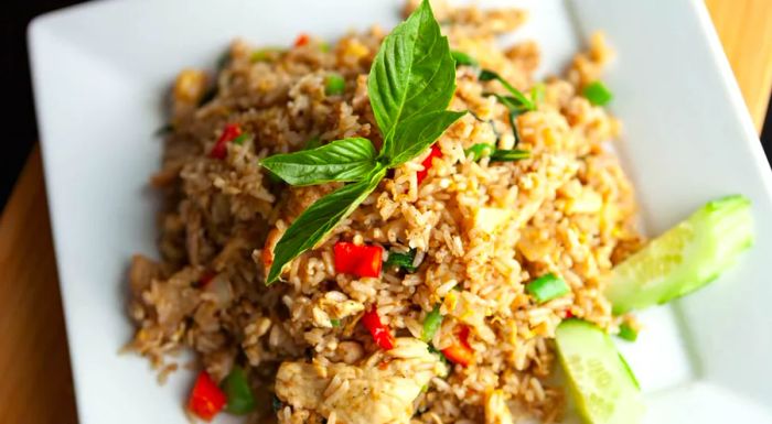 The key to Thai fried rice lies in its distinctive layering of flavors, a hallmark of the country's cuisine.