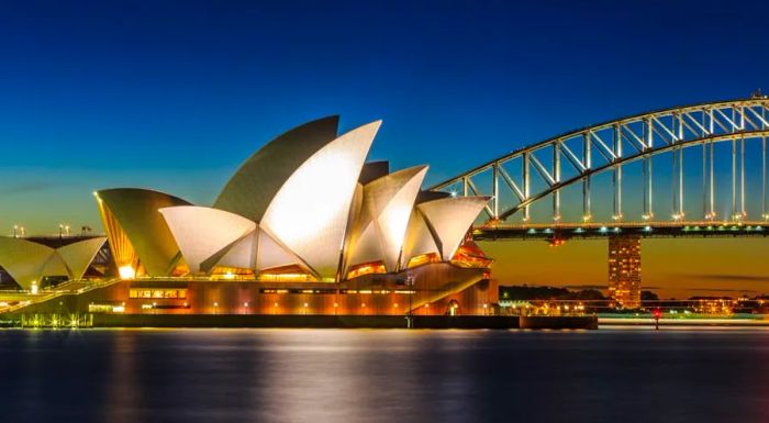 The Opera House stands alongside the Sydney Harbour Bridge, another iconic architectural marvel of the city.