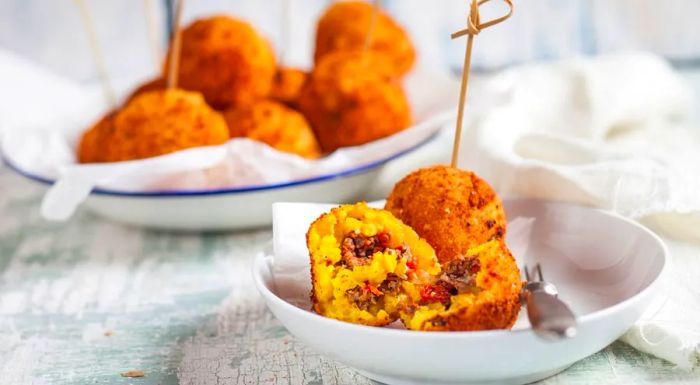 These stuffed, breaded, and fried rice balls are a quintessential street food in Sicily that you must try.