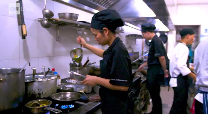 Employees prepare meals in the Hanoi KOTO kitchen.