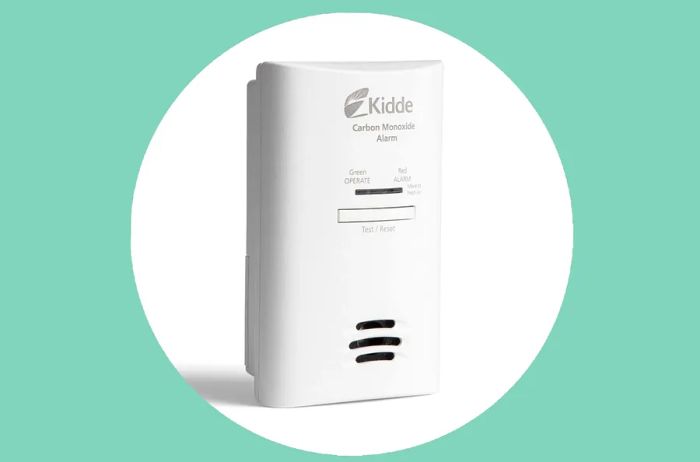 A small white carbon monoxide detector designed for travel, keeping you safe from this invisible threat wherever you go.