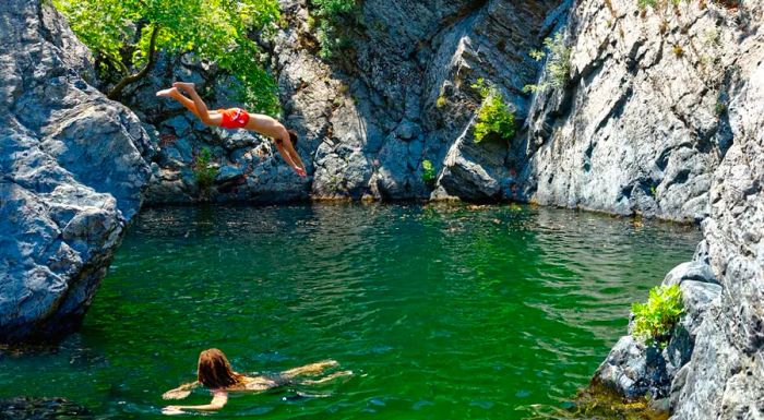 The island is renowned for its 'vathres,' natural pools created by the island's waterfalls.