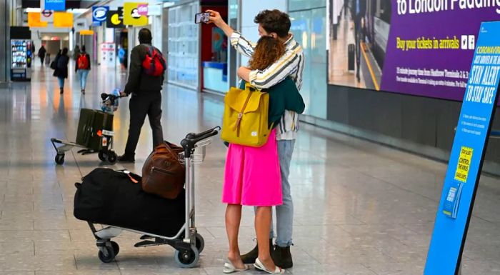 Travelers at Heathrow Airport – Getty Images