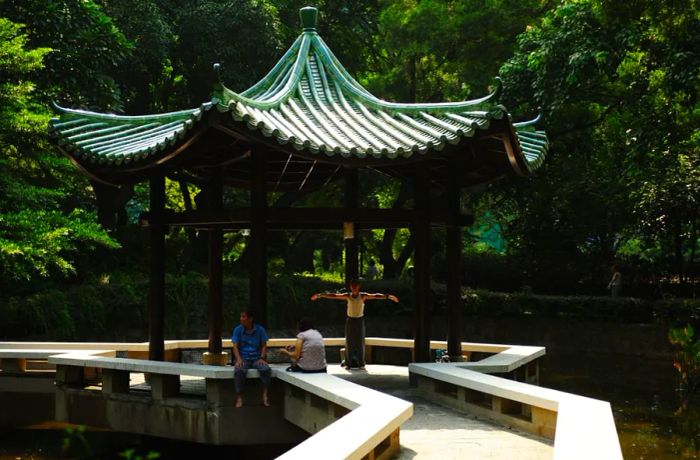 A man practices Tai Chi in Kowloon Park.