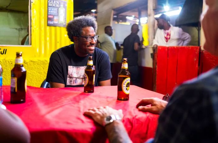 Nairobi, Kenya: Tony and Kamau share a beer at a local restaurant. Kamau mentions that the two of them spent a lot of time together off-camera during their time on location.