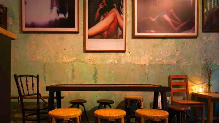 The walls of Teens of Thailand are adorned with provocative photography, adding to the venue's intense atmosphere.