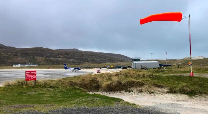 The windsock flutters briskly in the wind at Traigh Mhòr beach.