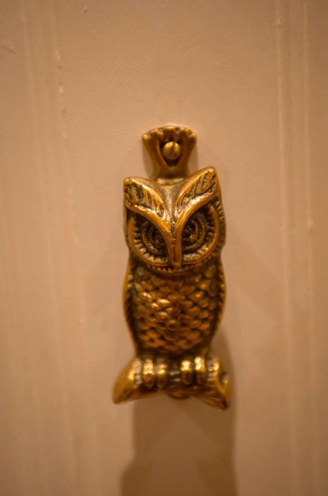 The brass owl door knocker for the Rowling Suite serves as a tribute to J.K. Rowling herself.