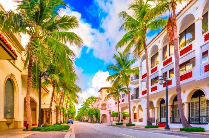 Brightly colored buildings line a street during the day.