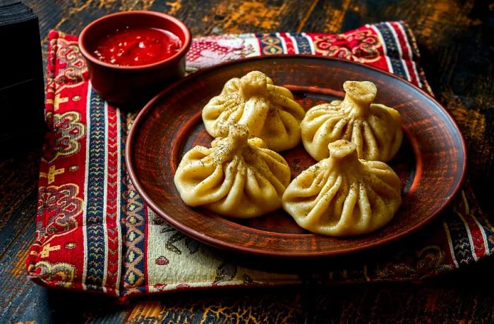 Khinkali are a unique type of dumpling, filled with savory meat and seasoned with spices, offering a perfect bite.