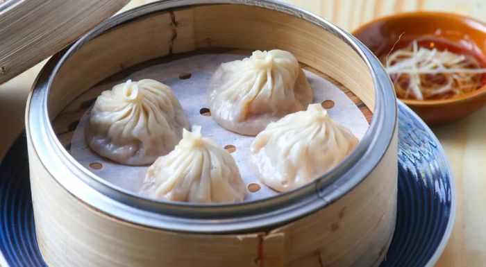 Xiaolongbao dumplings are made with aspic and are pinched at the top, rather than folded.