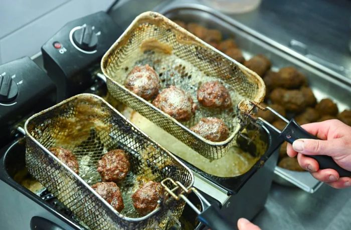 Raccoon meatballs being fried at Wildererhütte.