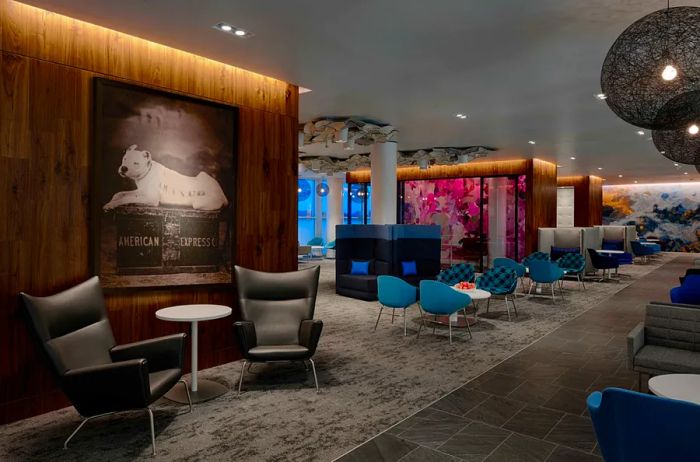 Main seating area featuring empty blue and gray chairs in the Centurion Lounge at Charlotte Airport