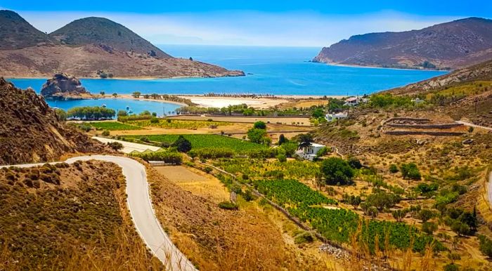 Petra beach is located just past some of the island's lush vineyards.