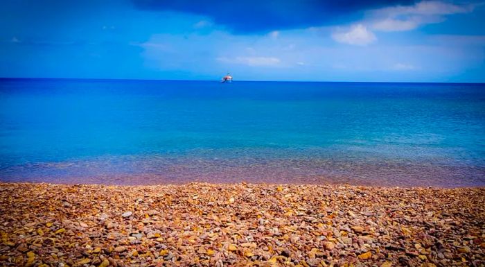 Lambi Beach is famous for its stunning multi-colored pebbles.