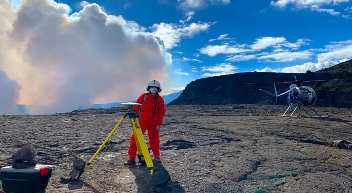 A Hawaiian Volcano Observatory geophysicist sets up equipment on December 21, 2020, to monitor changes in ground movement.