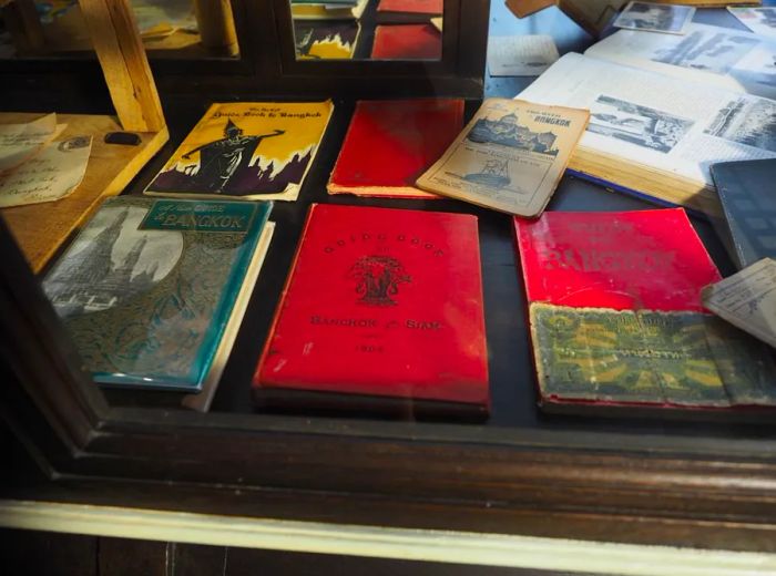 Original Bangkok guidebooks displayed in The Siam’s library.