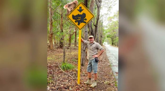 A drop bear — once again, we must emphasize that this is a photoshopped image and not real — gets ready to ambush Ian Coate of Mythic Australia.