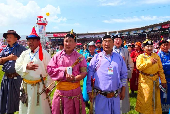 ULAN BATOR, Mongolia - Archers perform the national anthem during the opening ceremony of Naadam, a traditional summer sports festival, at the Central Stadium in Ulaanbaatar on July 11, 2014. The two-day event features competitions in Mongolian wrestling, horse racing, and archery. (Kyodo)