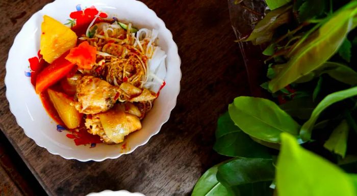 Kari sach moan, Cambodia’s take on red chicken curry, is a dish typically served during weddings and other special celebrations, making it a true taste of festivity in the country.