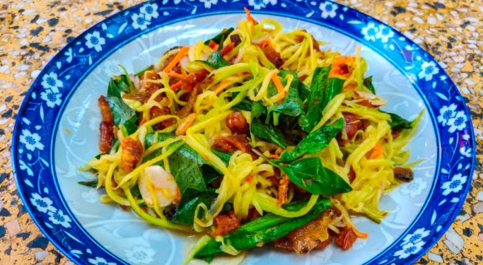 Cambodian salads frequently feature unripe fruits, like the tangy green mango in Nhoam svay kchai, a refreshing green mango salad.