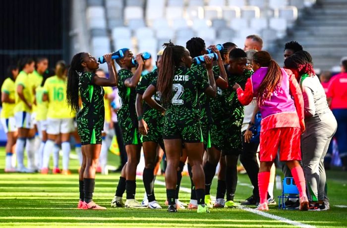 Hydration is essential for athletes. Here, the Nigerian women's soccer team takes a break to hydrate on July 25 during their match against Brazil in Bordeaux, France, at the 2024 Olympic Games.