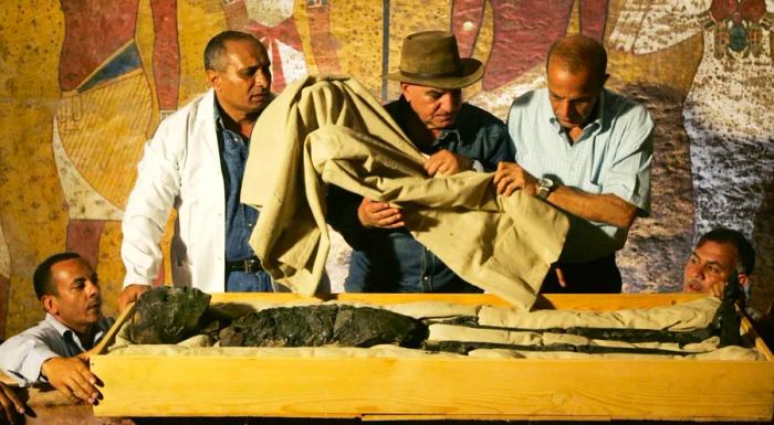 Zahi Hawass, Egypt's former antiquities minister, oversees the removal of King Tutankhamun's remains from his tomb in 2007, wearing his signature hat.