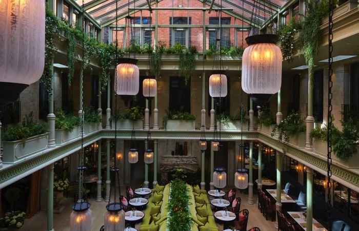 The grand atrium and restaurant at NoMad London, offering an airy and open atmosphere.