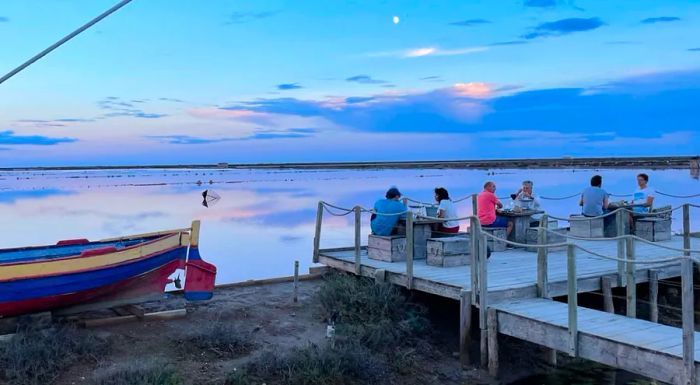 La Cambuse du Saunier, located near Gruissan, serves up fresh seafood at rustic driftwood tables, right by the water’s edge.