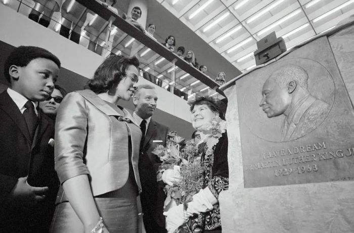 Coretta Scott King unveils a relief sculpture of her late husband at the Mugar Memorial Library on the Boston University campus.