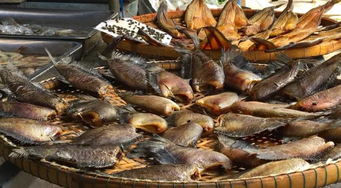 The market in front of Makkasan train station is filled with dried fish for sale, adding a unique local touch to the scene.