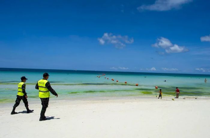 Police officers patrol the beach on the Philippine island of Boracay on April 26, 2018.