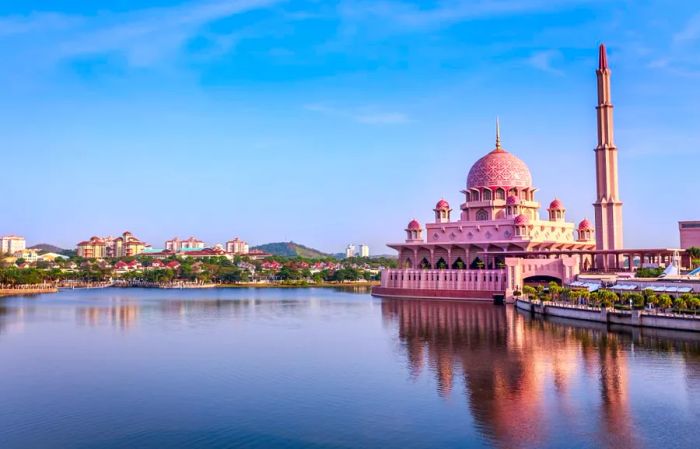 The Putra Mosque in Putrajaya, Malaysia, sits at the edge of a serene manmade lake.