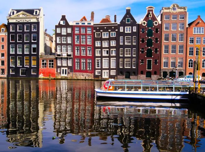 Amsterdam, the official capital of the Netherlands, is lined with traditional houses along its picturesque canals.