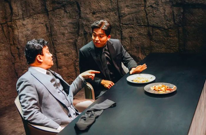 Sung Anh, seen on the right, engages in a lively discussion about dishes with his fellow judge, Paik Jong-won, on 'Culinary Class Wars.'