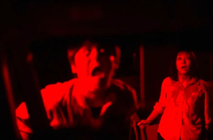 Actors put on a haunting red-light performance at a drive-in haunted house in Tokyo.