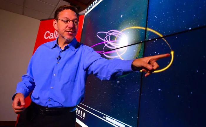 On January 20, 2016, Caltech astronomer Mike Brown presented the 'predicted orbit' of the hypothesized Planet Nine, marked in yellow, during a talk at Caltech's Seismology Lab in Pasadena, California. Brown, along with his colleague Konstantin Batygin, shared what they believed to be compelling evidence of a hidden planet on the outskirts of our solar system.