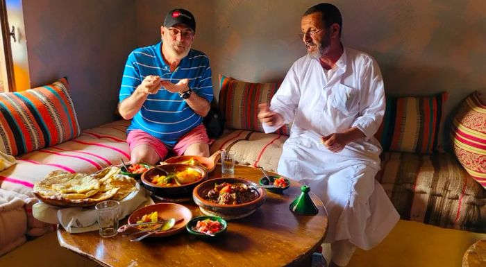 The author and his host enjoy tasting the fruits of his Berber cooking lesson.