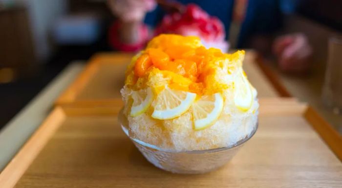 In this Japanese treat, kakigori, a mix of citrus syrup is drizzled over finely shaved ice.